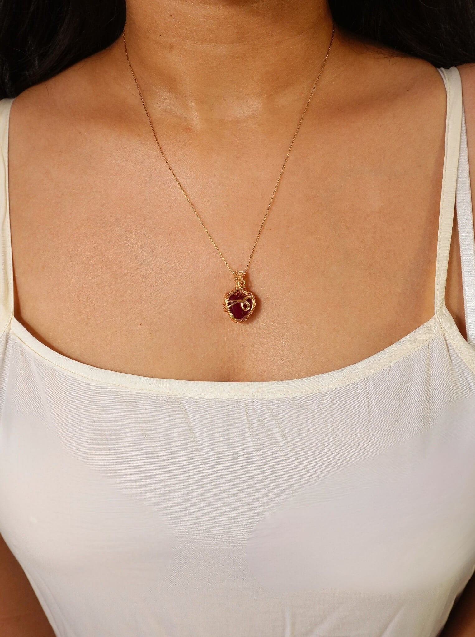 Handmade Red Chalcedony crimson heart pendant necklace with gold wire wrapping worn on model – devotion and passion crystal jewelry handcrafted in Sri Lanka, meaningful gift for her
