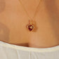 Close-up of Red Chalcedony heart pendant necklace with intricate gold wire wrapping worn on model – handmade healing crystal jewelry from Sri Lanka, warm tones love jewelry
