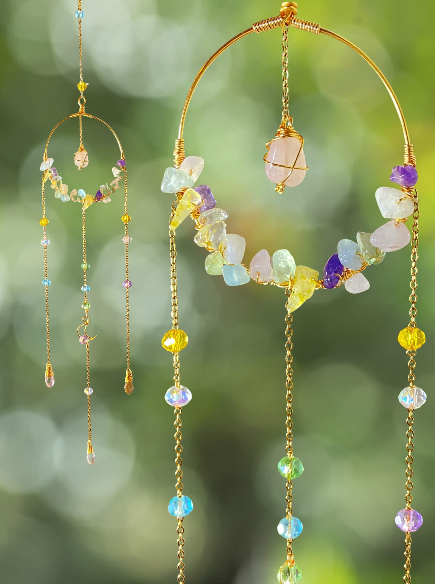 Handmade crystal blessing suncatcher featuring wire-wrapped rose quartz, amethyst, citrine, aquamarine, fluorite gemstones and rainbow glass beads on gold brass hoop catching natural light - bohemian healing crystal home decor from Sri Lanka for positive energy