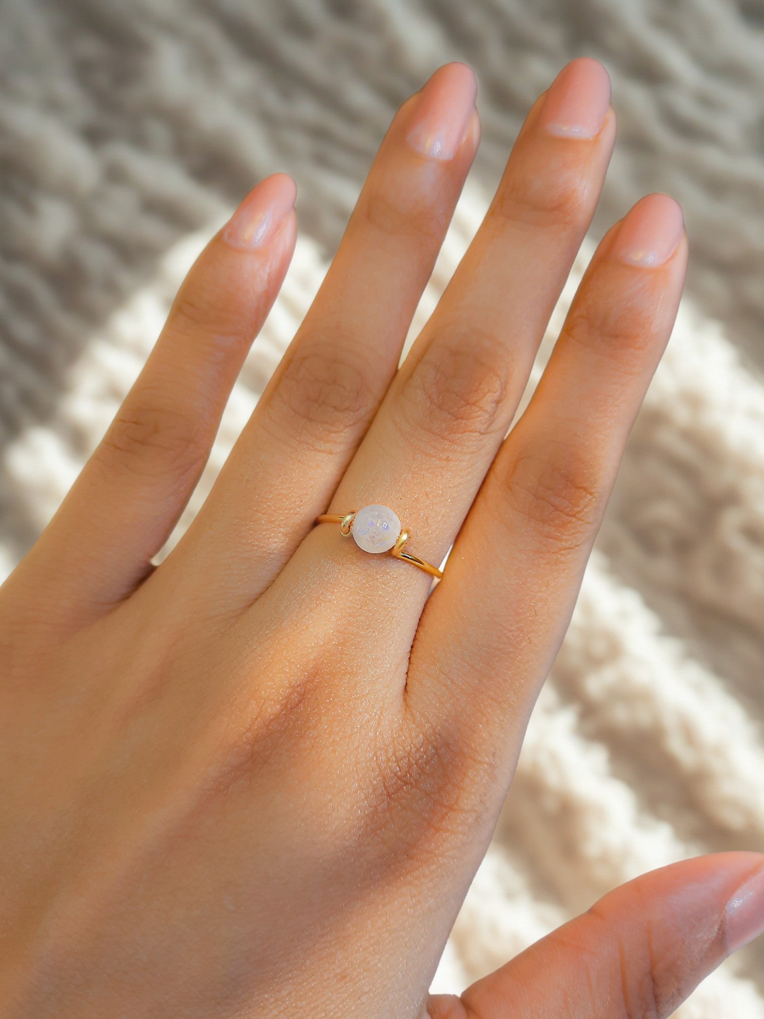 Laganna handmade dainty round moonstone gold wire wrapped ring for intuition and feminine energy worn on hand

