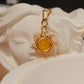 Eternal Sun Necklace Yellow Onyx gold wire sun pendant resting on white goddess sculpture artistic flat lay, handmade healing crystal necklace Sri Lanka Laganna