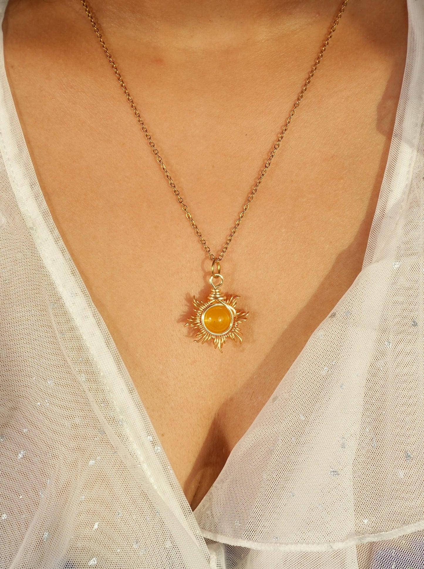 Eternal Sun Necklace with Yellow Onyx gold wire wrapped sun pendant worn on model close-up view, handmade healing crystal willpower necklace Sri Lanka by Laganna