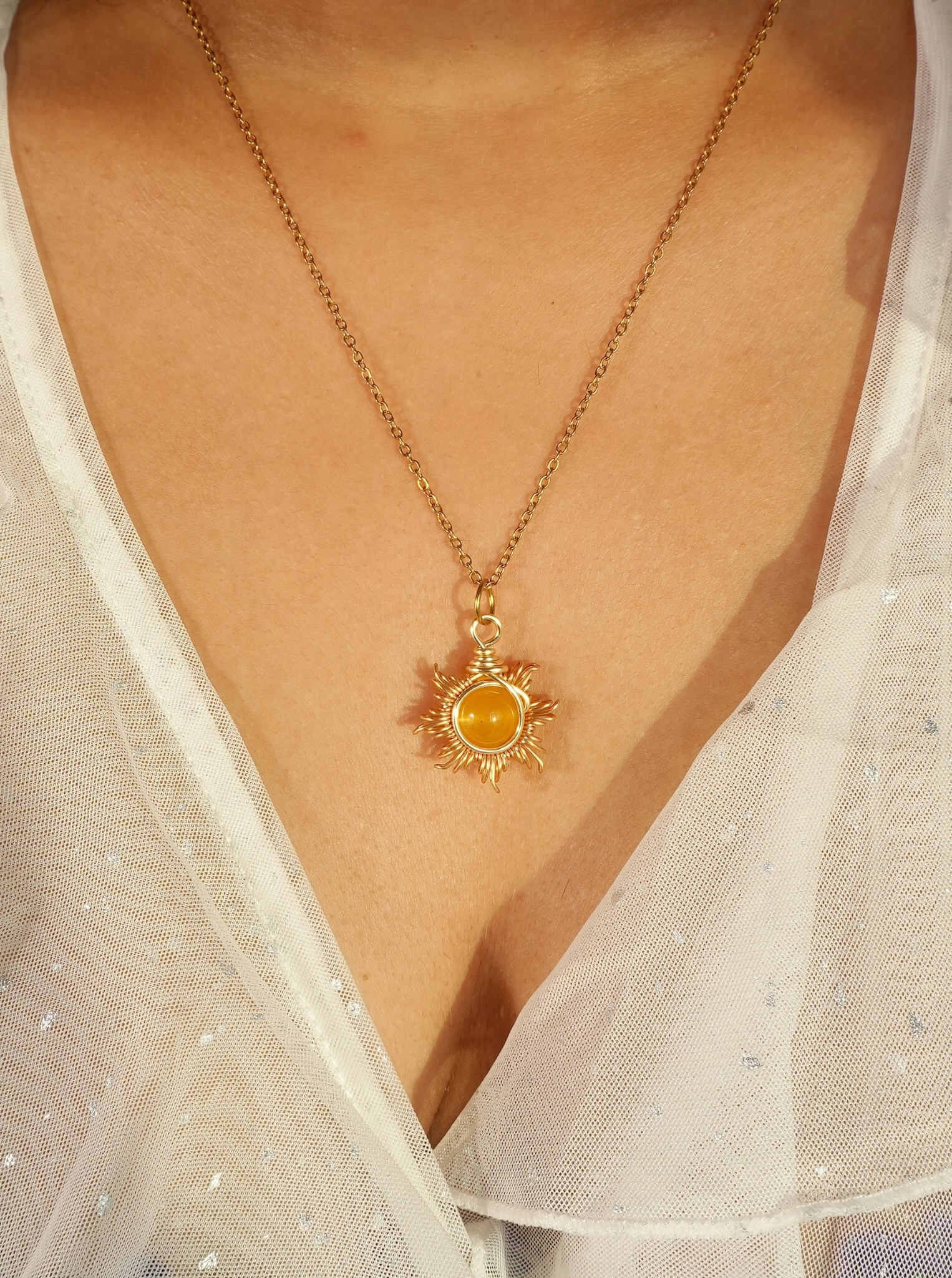 Eternal Sun Necklace with Yellow Onyx gold wire wrapped sun pendant worn on model close-up view, handmade healing crystal willpower necklace Sri Lanka by Laganna