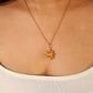 Eternal Sun Necklace Yellow Onyx radiant gold wire wrapped sun pendant on model white top front view, handmade healing crystal jewelry Sri Lanka Laganna