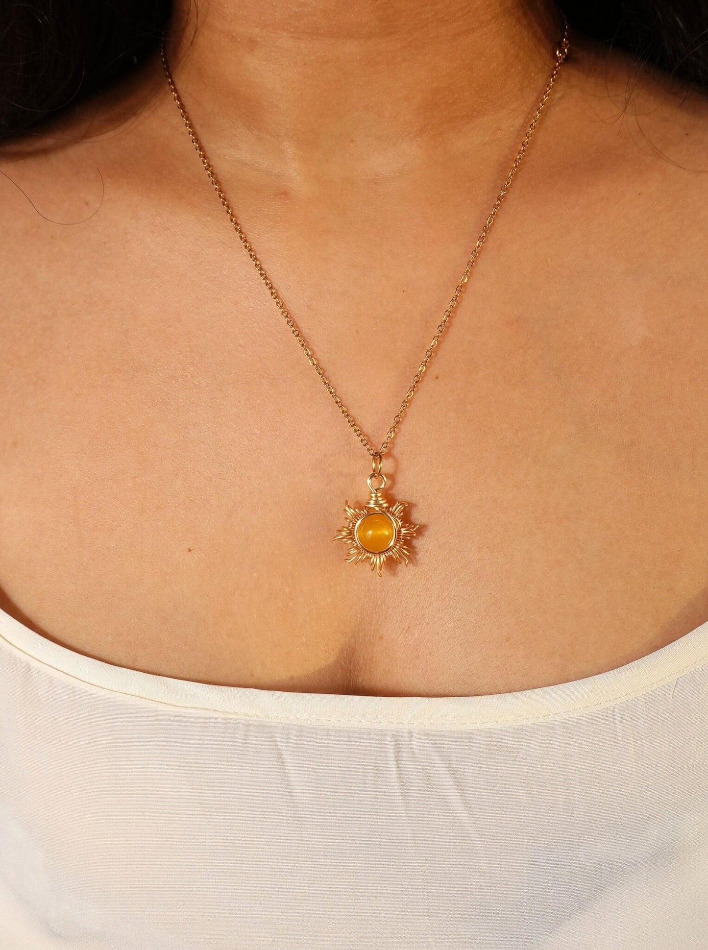 Eternal Sun Necklace Yellow Onyx radiant gold wire wrapped sun pendant on model white top front view, handmade healing crystal jewelry Sri Lanka Laganna