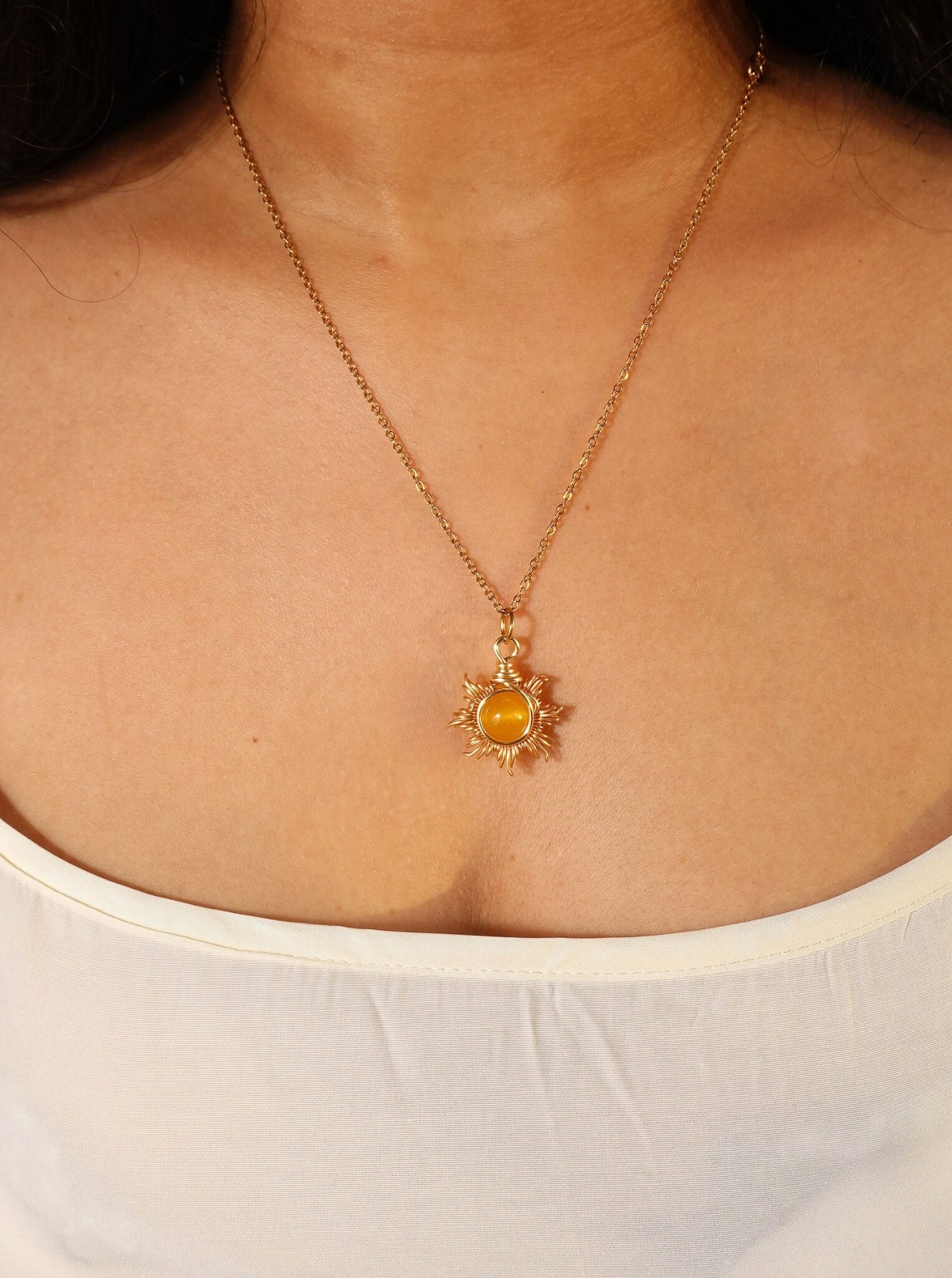 Eternal Sun Necklace Yellow Onyx radiant gold wire wrapped sun pendant on model white top front view, handmade healing crystal jewelry Sri Lanka Laganna