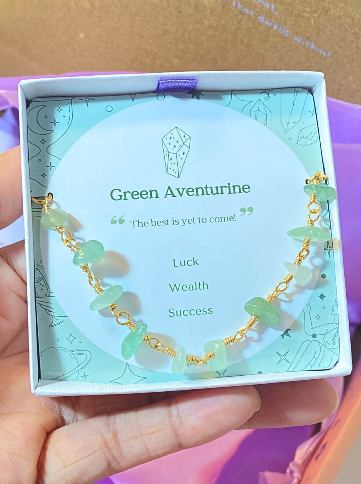 Fortune Bracelet Green Aventurine worn on hand showcasing gold wire wrapped design and natural green stones, handmade Sri Lankan healing crystal bracelet for wealth and success