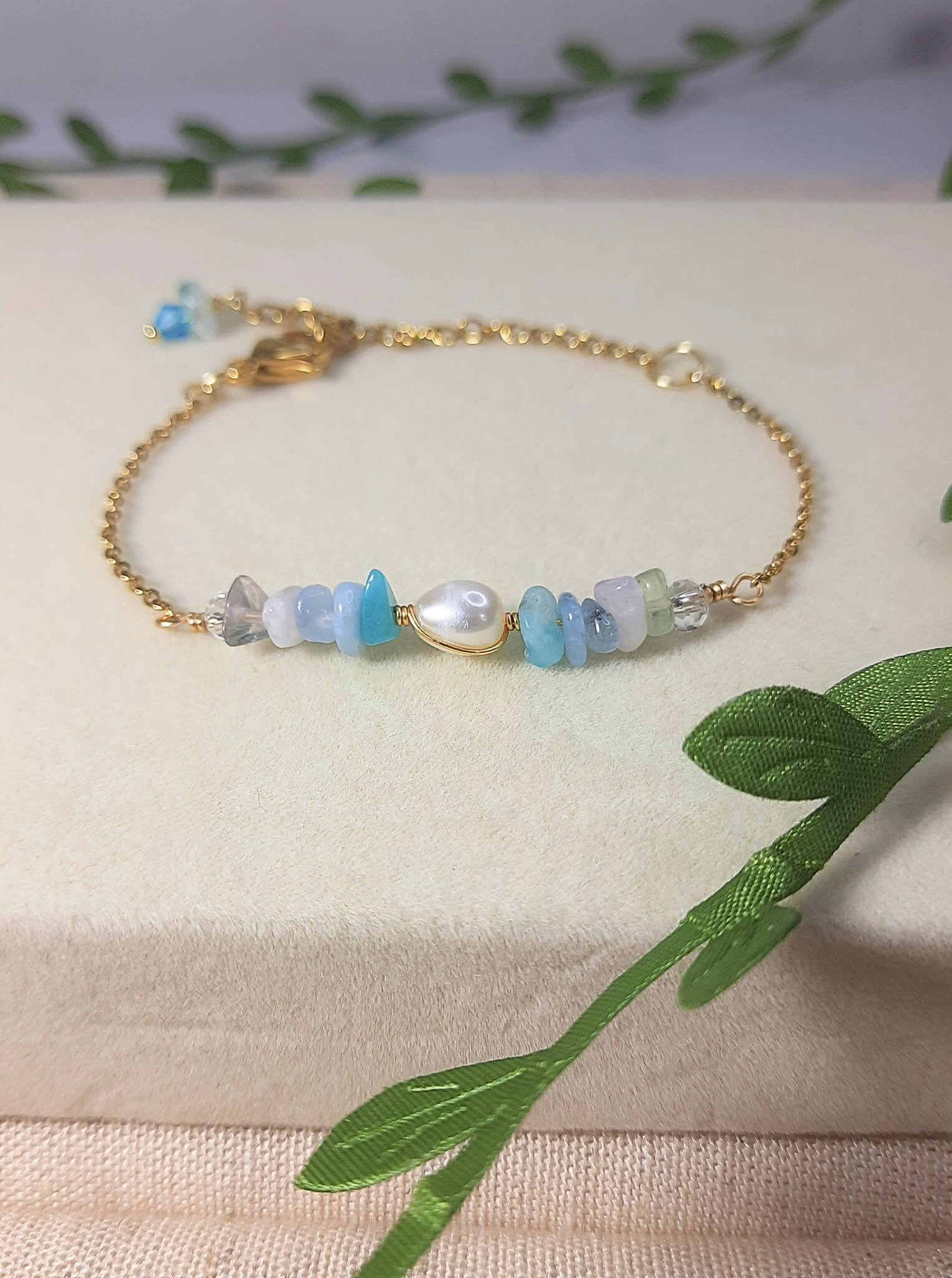 Close-up detail of Freshwater Lake Bracelet showing intricate gold wire wrapping technique with water-inspired crystals, handmade craftsmanship from Sri Lanka