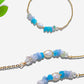 Freshwater Lake Bracelet on white background displaying gold wire wrapped crystals in tranquil blue and aqua tones, handmade in Sri Lanka