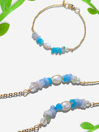 Freshwater Lake Bracelet on white background displaying gold wire wrapped crystals in tranquil blue and aqua tones, handmade in Sri Lanka