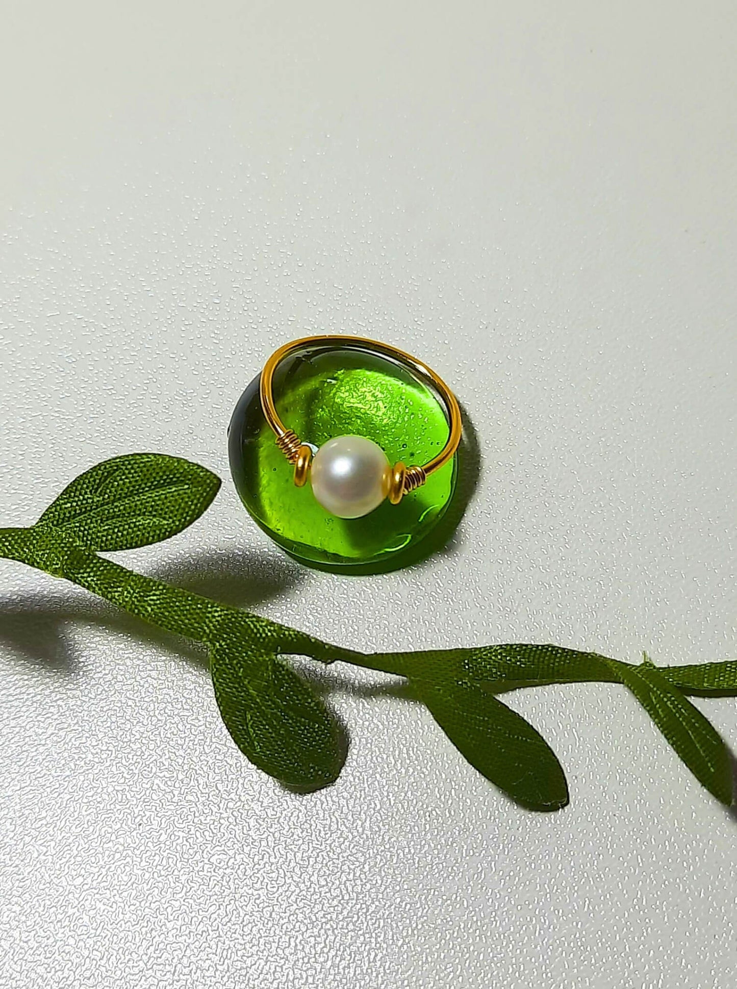 Freshwater pearl dainty ring closeup showing delicate gold wire wrapped design on white background, handmade Sri Lankan pearl jewelry for serenity, emotional balance, and timeless beauty
