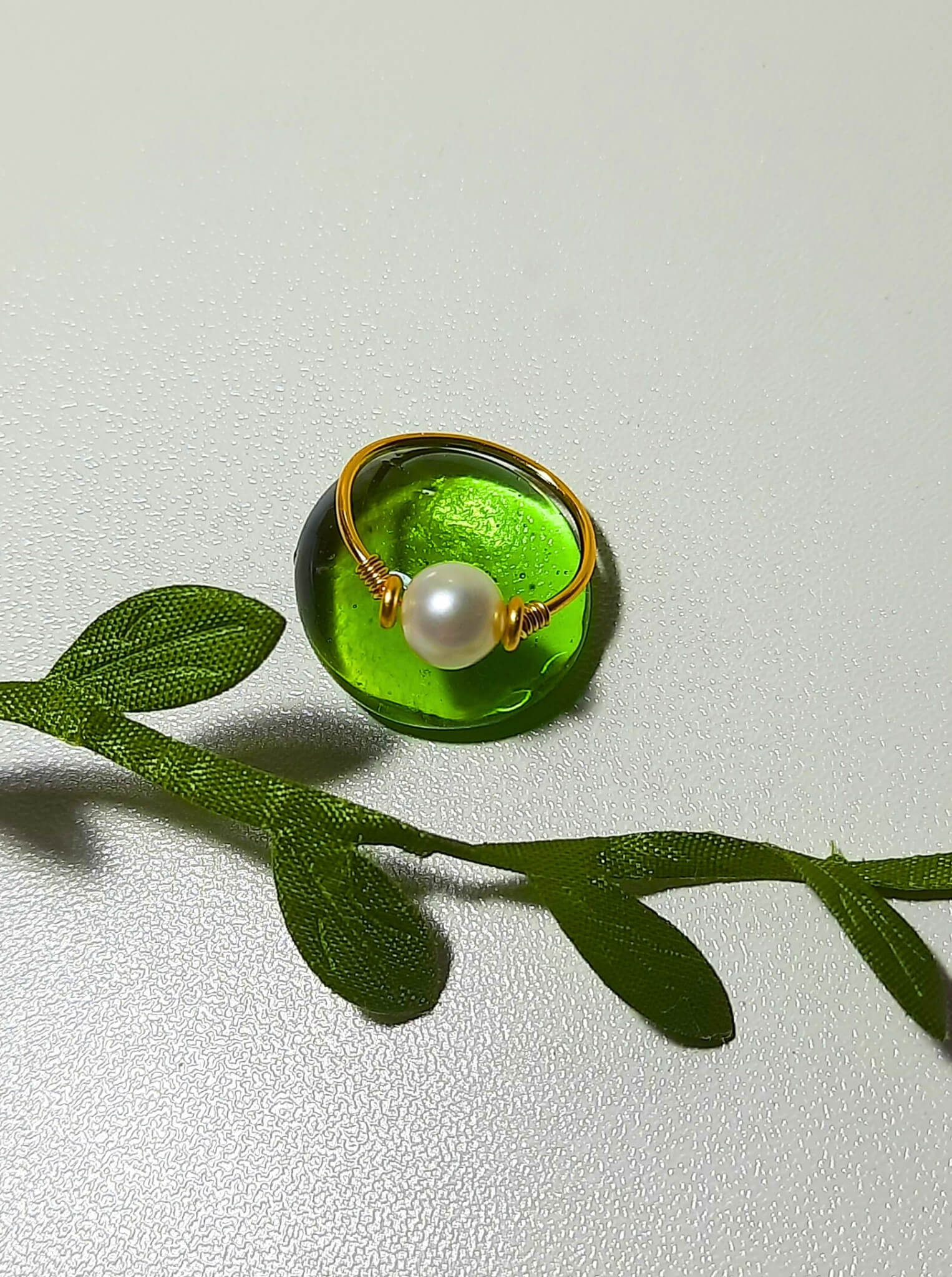 Freshwater pearl dainty ring closeup showing delicate gold wire wrapped design on white background, handmade Sri Lankan pearl jewelry for serenity, emotional balance, and timeless beauty

