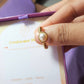 Freshwater pearl ring jewelry box held in hand showing gold wire wrapped design, handmade Sri Lankan pearl jewelry gift for elegance and grace