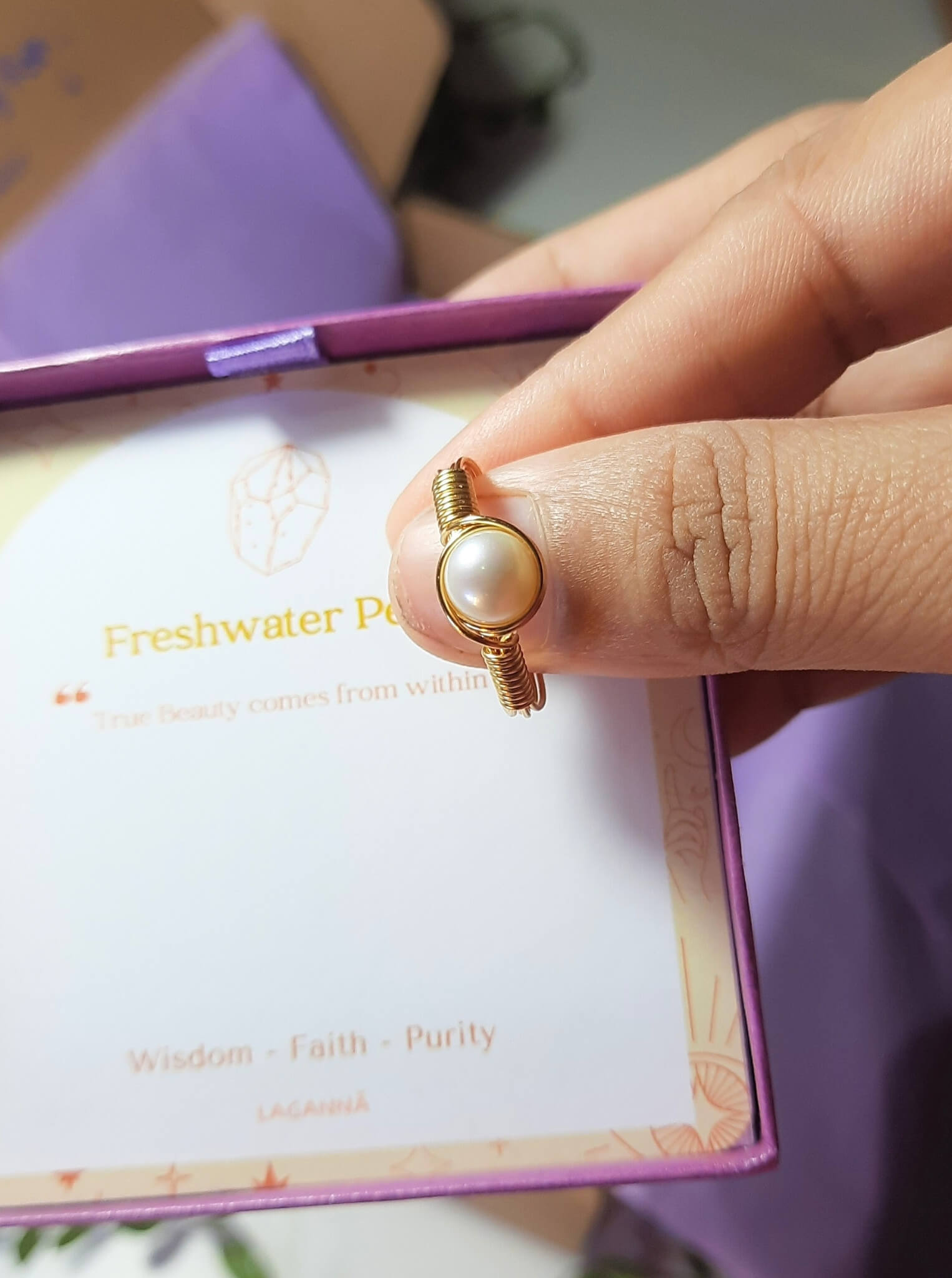 Freshwater pearl ring jewelry box held in hand showing gold wire wrapped design, handmade Sri Lankan pearl jewelry gift for elegance and grace
