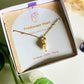 Freshwater pearl necklace in elegant jewelry box aesthetic styling, handmade Sri Lankan gold wire wrapped pendant for emotional balance and tranquility