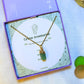 Laganna handmade green aventurine irregular stone gold necklace for luck, wealth and success displayed in purple Laganna box on aesthetic background