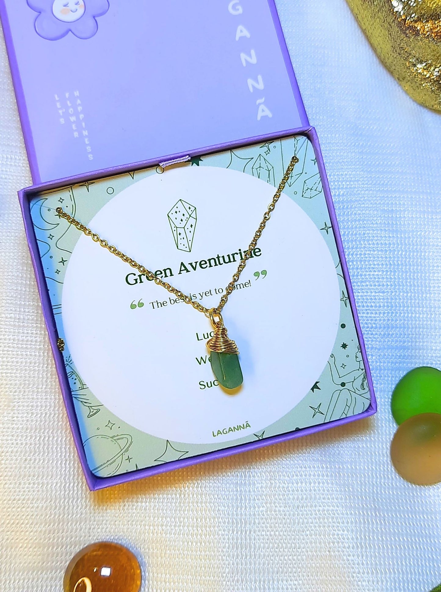 Laganna handmade green aventurine irregular stone gold necklace for luck, wealth and success displayed in purple Laganna box on aesthetic background