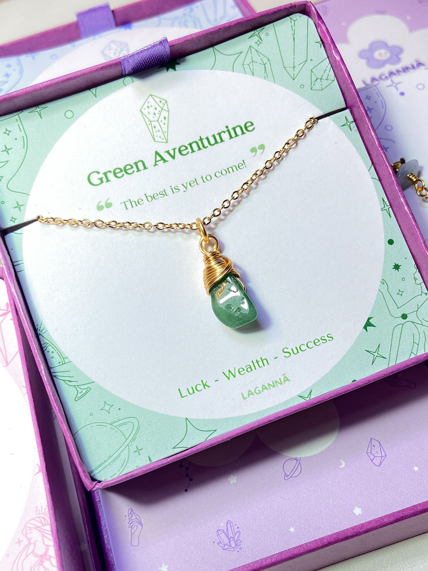Laganna handmade green aventurine irregular stone gold necklace for luck, wealth and success displayed in purple Laganna box