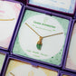 Laganna handmade green aventurine irregular stone gold necklace for luck, wealth and success displayed in purple Laganna box with jewelry stack