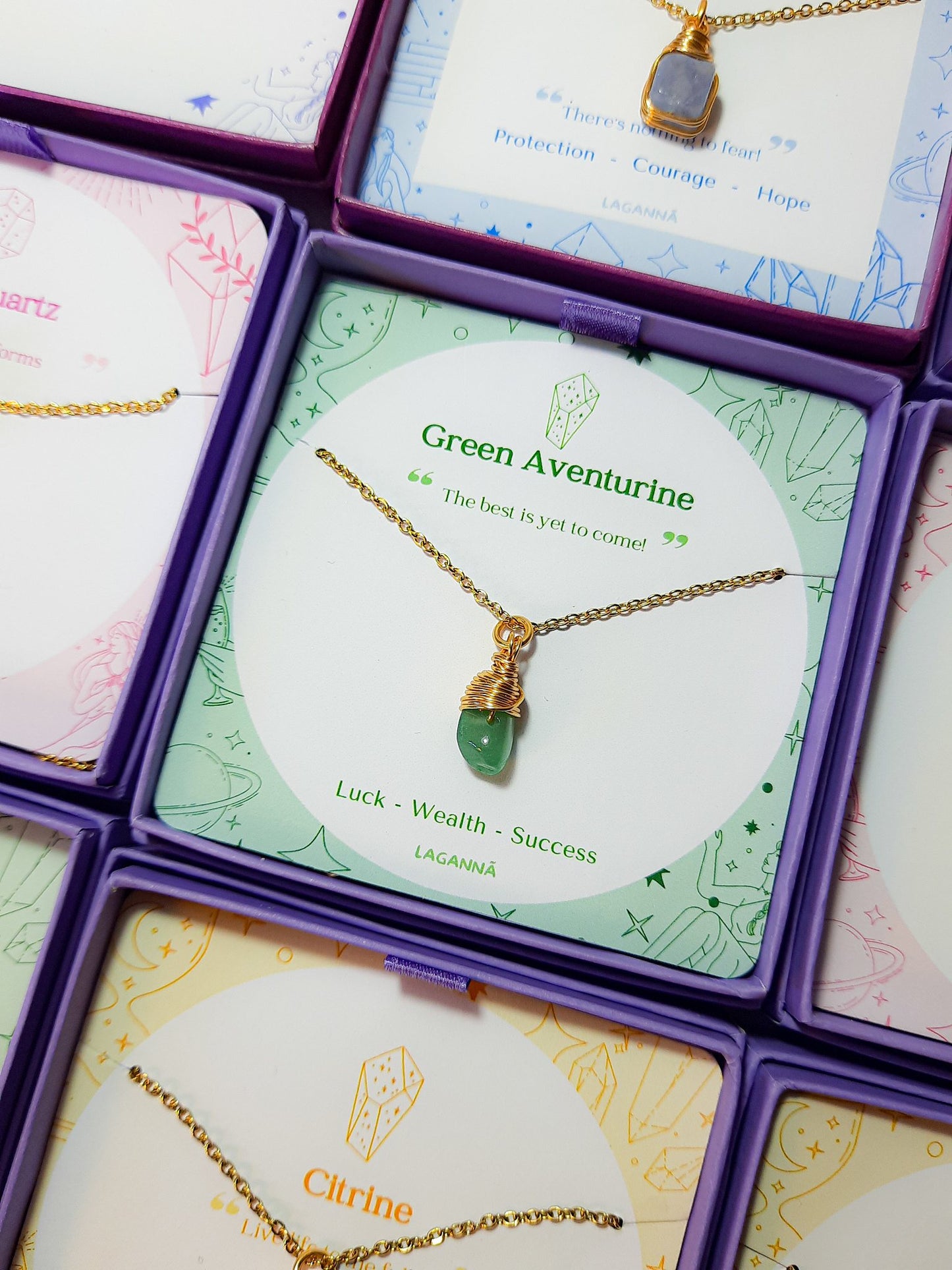 Laganna handmade green aventurine irregular stone gold necklace for luck, wealth and success displayed in purple Laganna box with jewelry stack