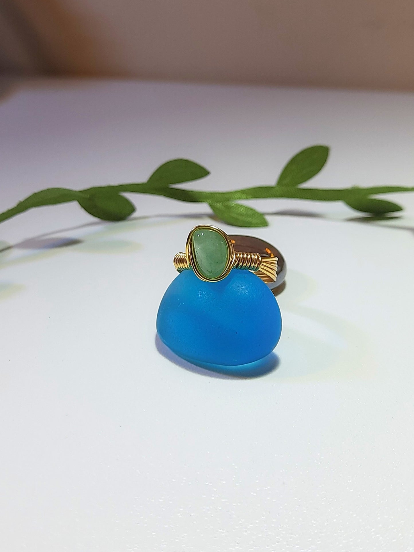  Green aventurine irregular stone ring side view showing handmade gold wire wrapped healing crystal jewelry with natural leaves, Sri Lankan spiritual ring featuring raw green gemstone perfect as boho luck stone ring and protective amulet for prosperity and growth enhancement