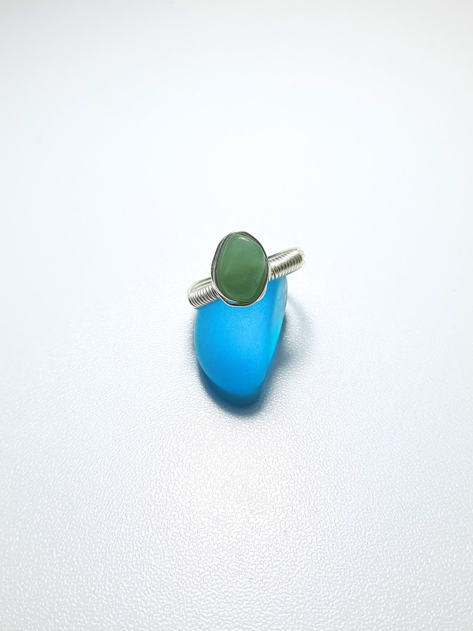 Handmade green aventurine irregular stone ring in silver wire wrapped design on white background featuring natural healing crystal jewelry, Sri Lankan artisan luck stone ring with raw green gemstone perfect as boho prosperity ring and heart chakra balancing amulet