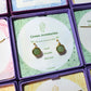 Green Aventurine Statement Round Stud Earrings packaging with crystal meaning card - handcrafted wire-wrapped healing jewelry gift from Sri Lanka featuring natural green aventurine stone for luck, wealth, and success
