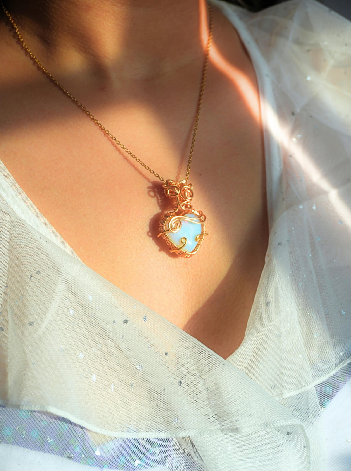 Handmade Opalite heart pendant necklace with gold wire wrapping worn on model – hope and heaven crystal jewelry handcrafted in Sri Lanka, meaningful gift for her
