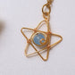 Beautiful heavenly blue star necklace with blue chalcedony on clean white background side view, featuring delicate celestial gold wire wrapping - artisan-crafted healing crystal jewelry handmade in Sri Lanka by Laganna