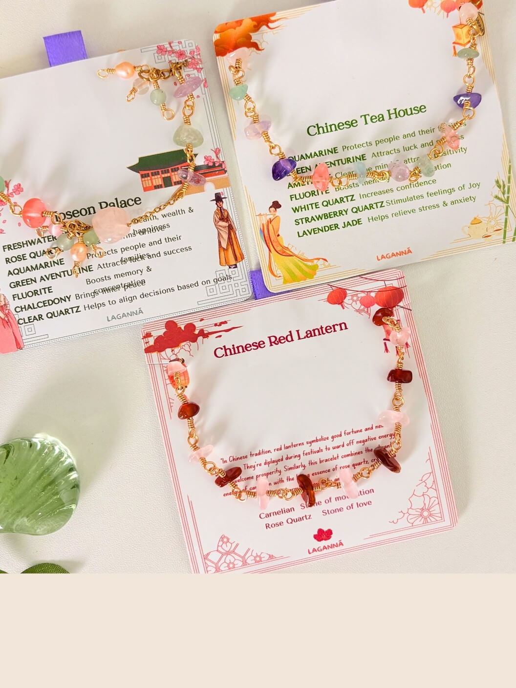 Three cards with laganna jewelry Chinese-themed designs and product information on a white surface.