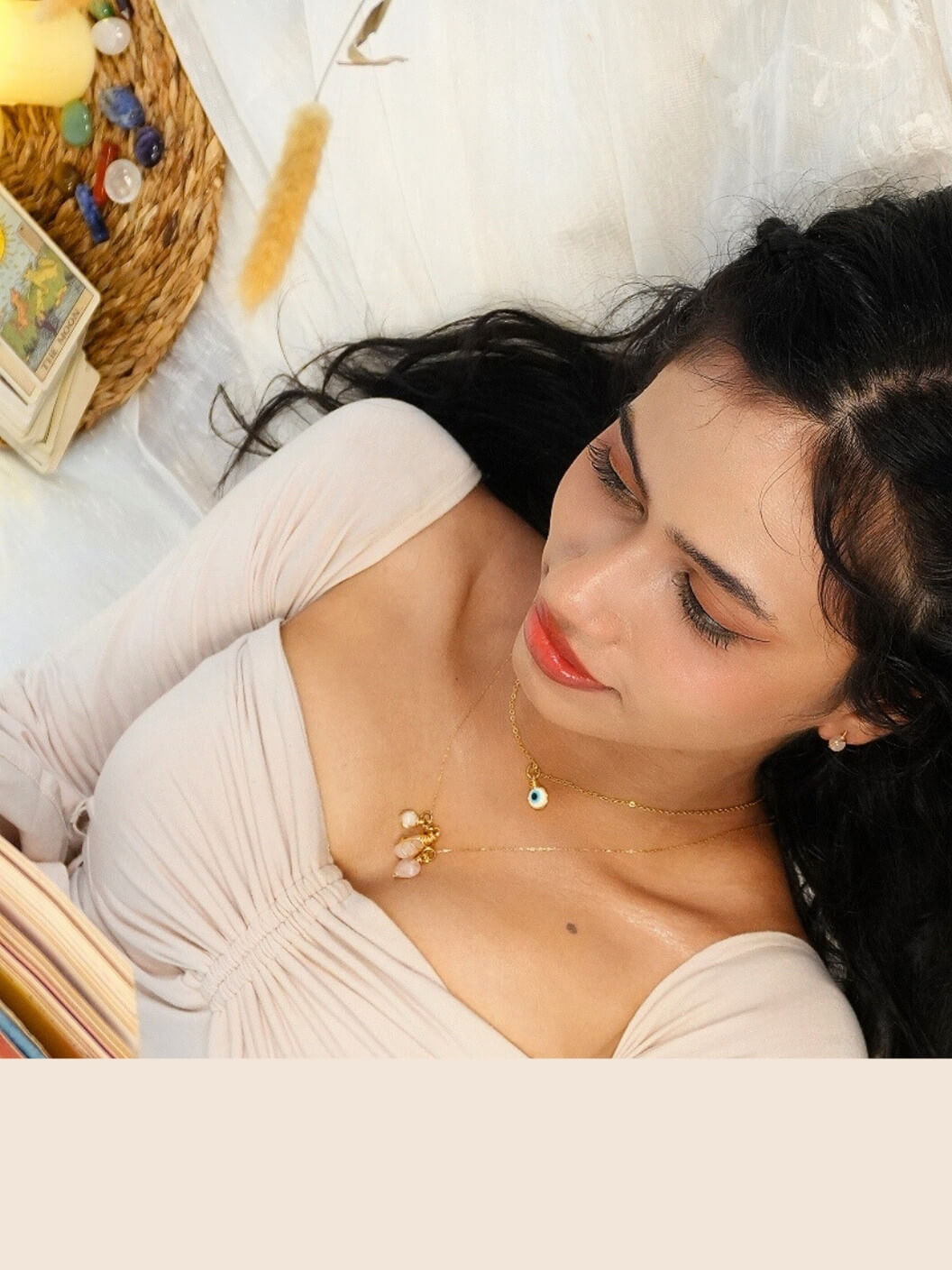 Woman lying wearing a necklace with a laganna pendant necklace