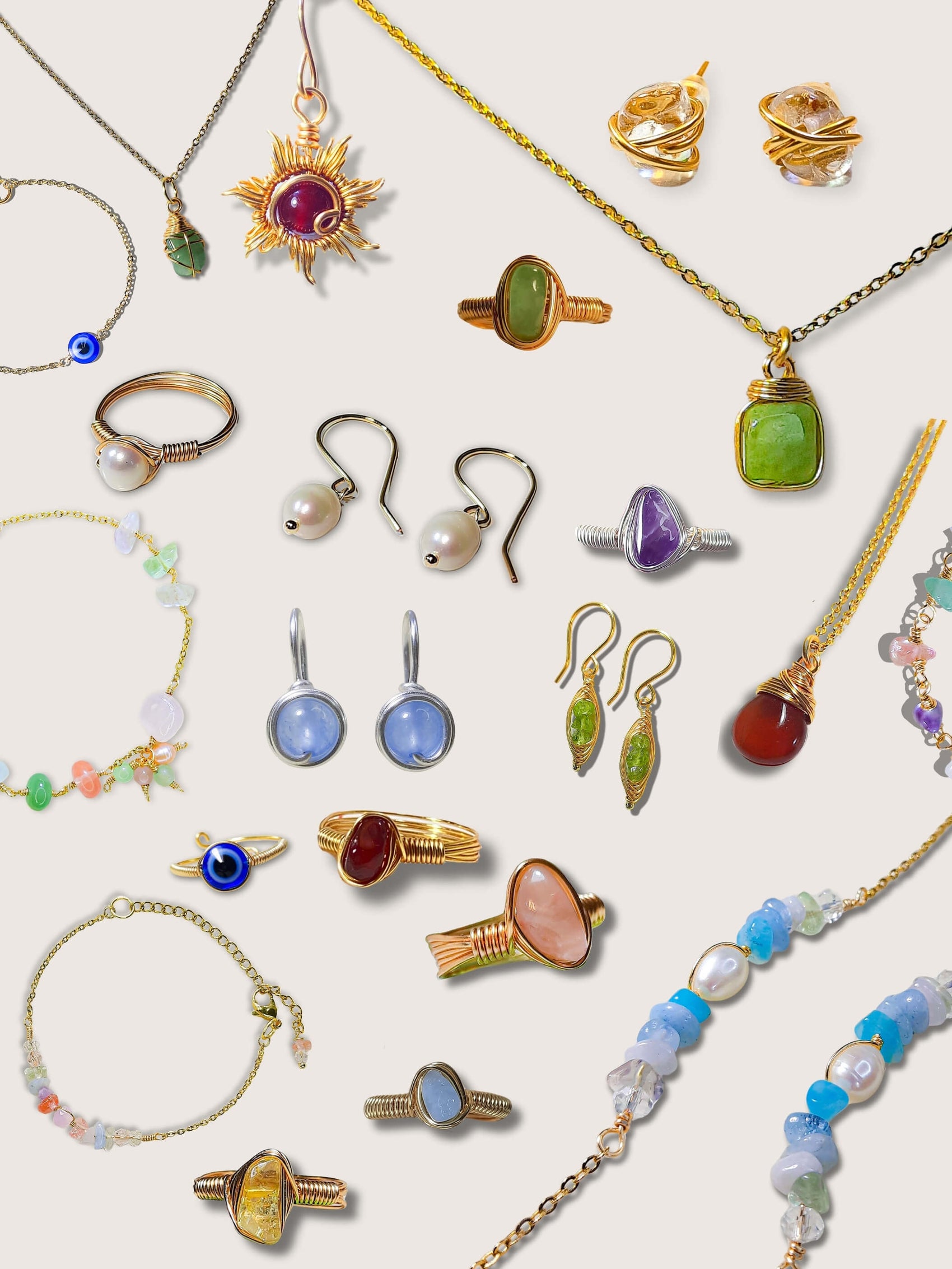Assorted jewelry including rings, earrings, and necklaces on a light background