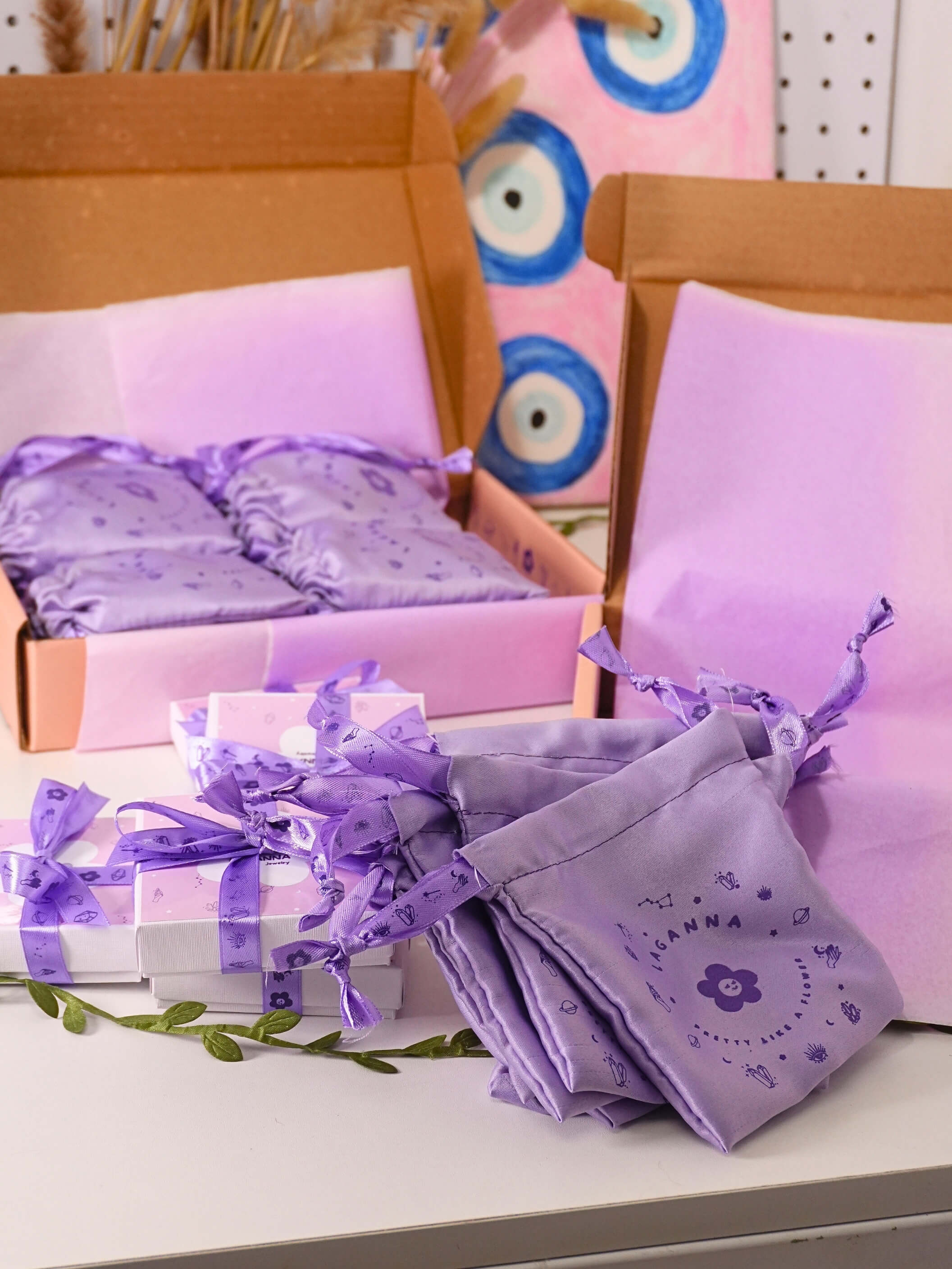 Purple laganna packaging items with ribbons on a table and in a box