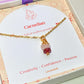 Love Duo irregular stone necklace with rose quartz and carnelian jewelry box closeup side view, handmade Sri Lankan gold wire wrapped dual crystal pendant for love and creativity