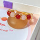 Love Duo braided ring with rose quartz and carnelian jewelry box closeup, handmade Sri Lankan gold wire wrapped dual crystal ring for love and confidence