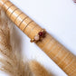 Love Duo Ring rose quartz and carnelian gold wire wrapped resting on bamboo prop with pampas grass flat lay, handmade healing crystal ring Sri Lanka – love creativity emotional balance Laganna
