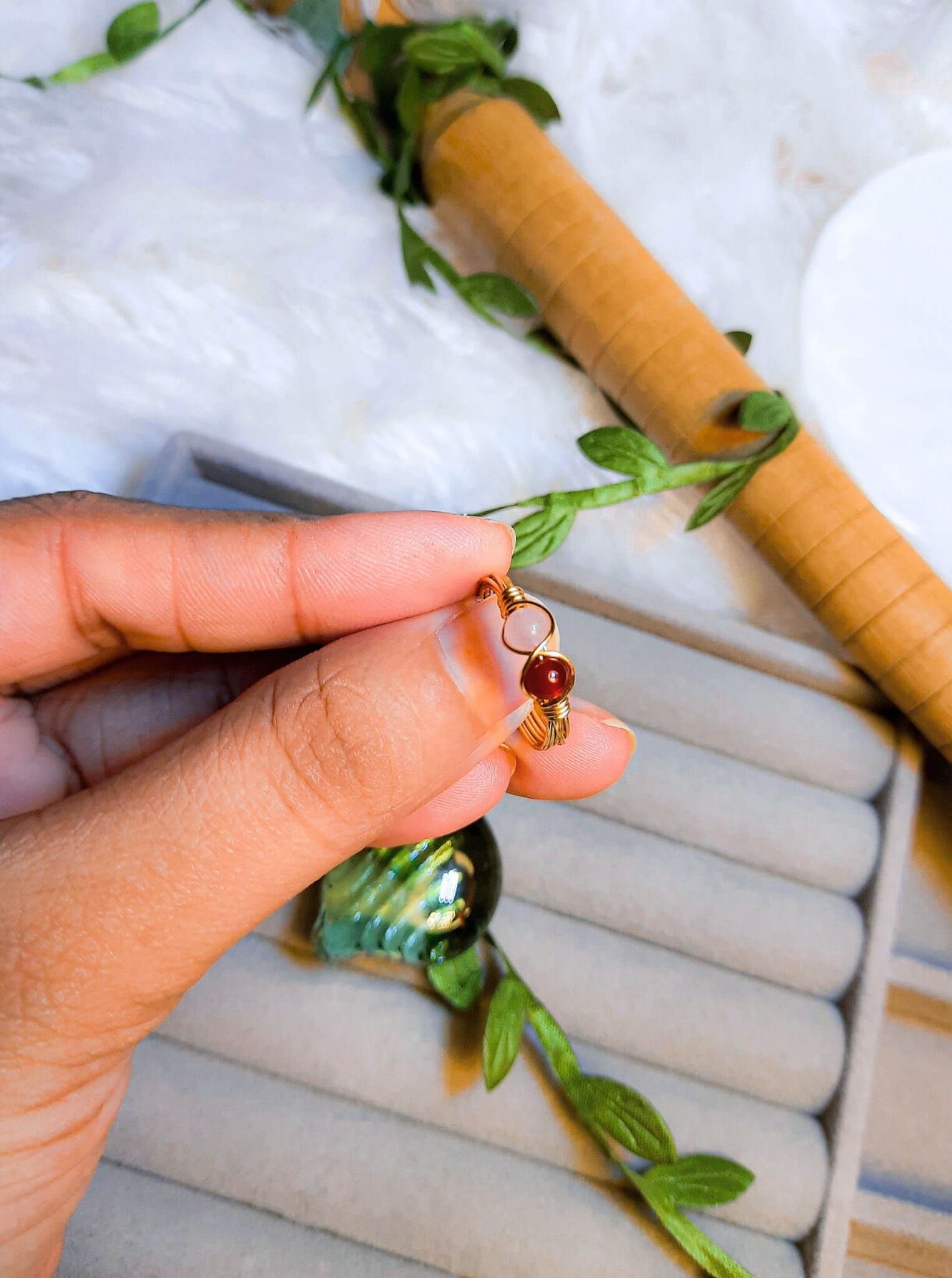 Love Duo ring with rose quartz and carnelian held on hand, handmade Sri Lankan gold wire wrapped dual crystal ring for self-love and creative energy