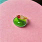 Love Duo ring with rose quartz and carnelian on pink background, handmade Sri Lankan gold wire wrapped dual stone ring for love and creativity