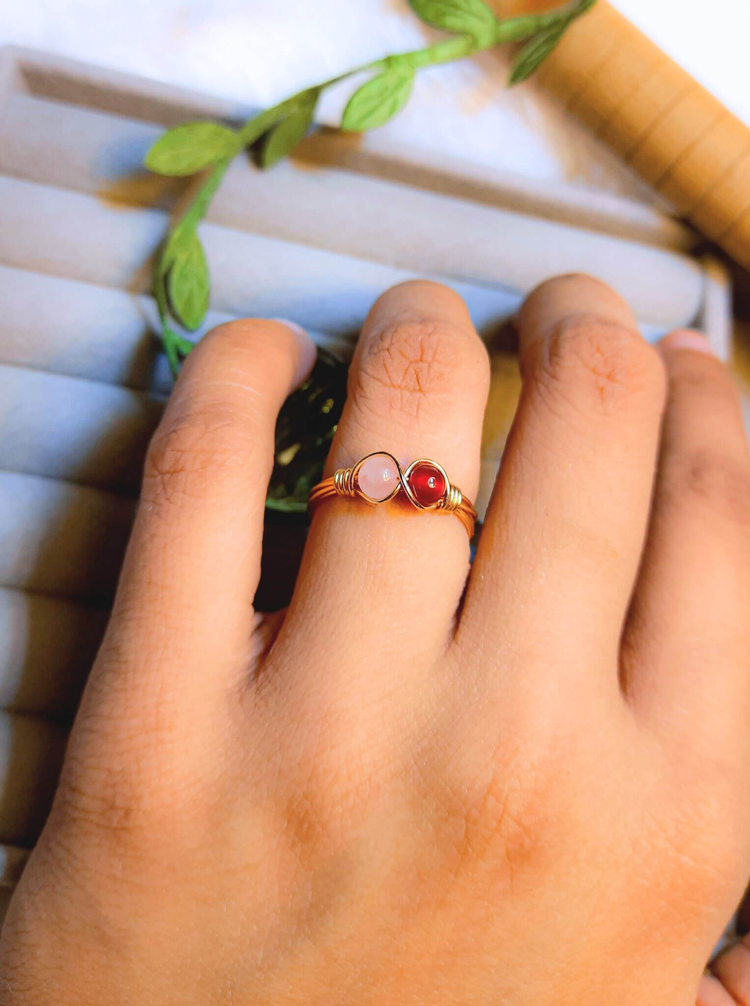 Love Duo ring with rose quartz and carnelian worn on hand, handmade Sri Lankan gold wire wrapped dual stone ring lifestyle for heart chakra and sacral chakra
