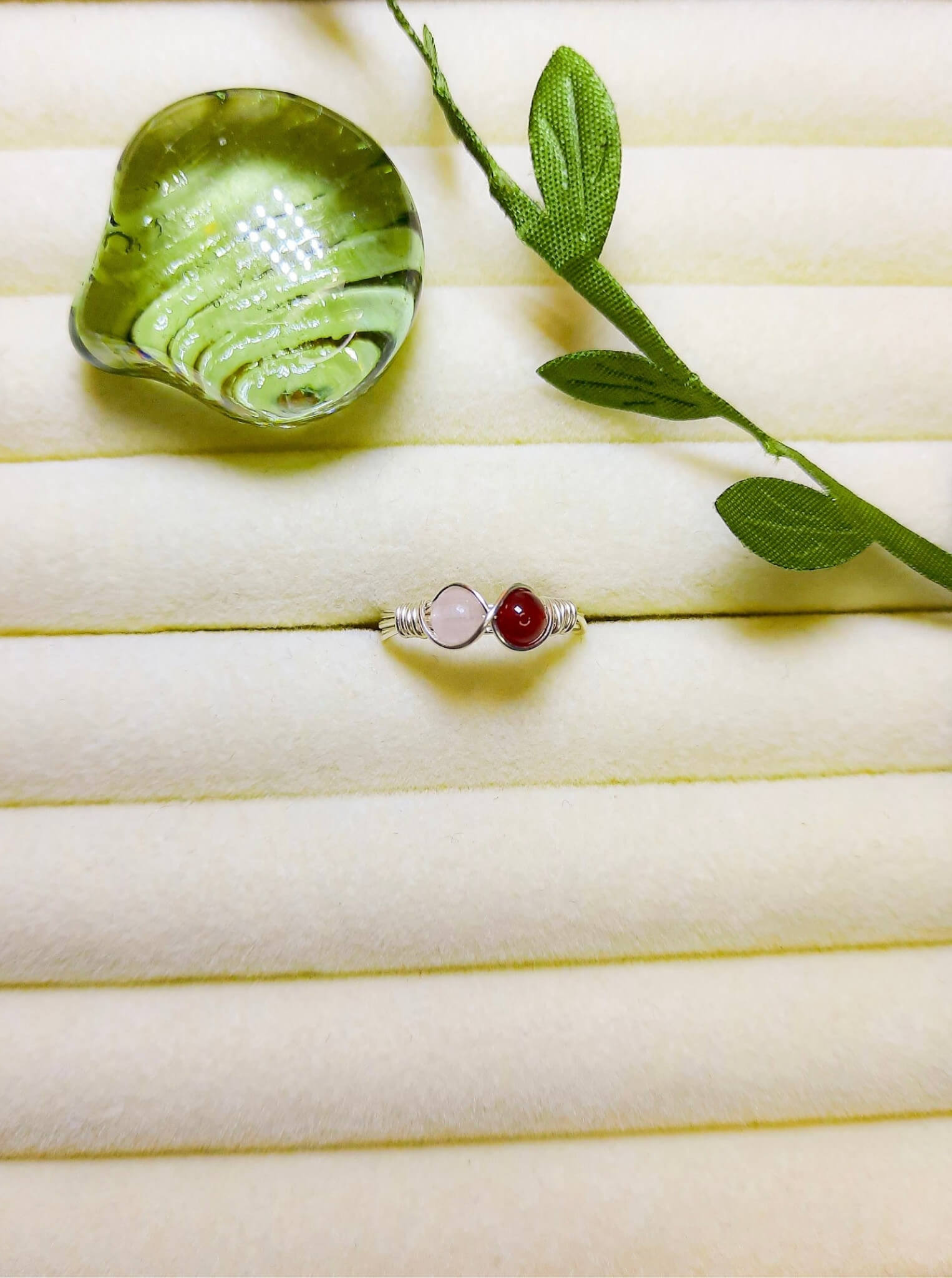  Love Duo ring with rose quartz and carnelian on jewelry display, handmade Sri Lankan silver wire wrapped dual stone ring for emotional balance and motivation