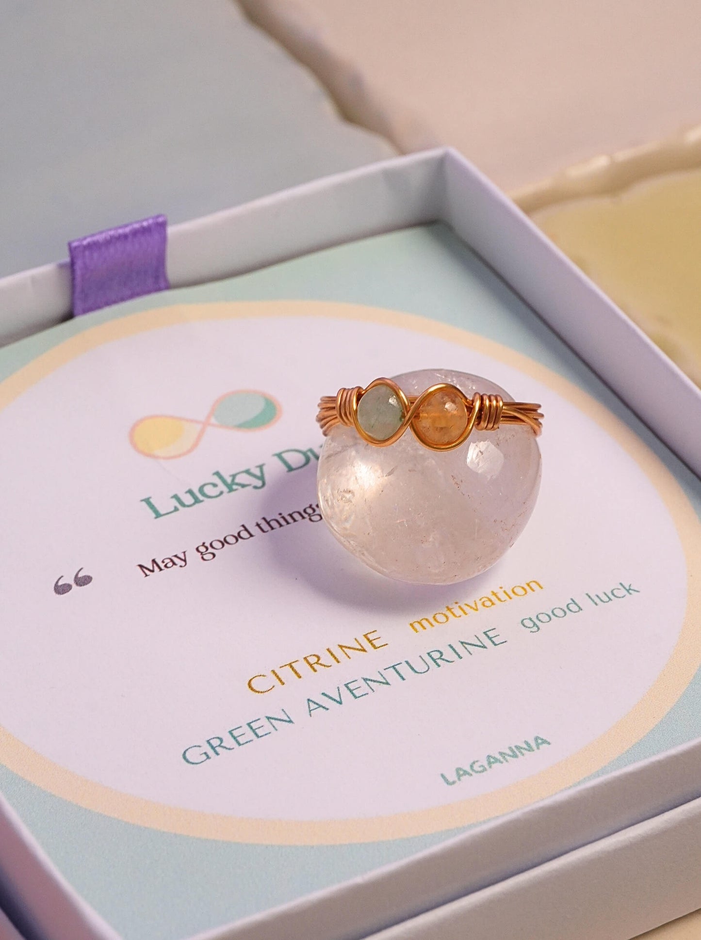 Lucky Duo Ring Green Aventurine and Citrine gold wire infinity wrapped displayed on rose quartz sphere Laganna gift box, handmade healing crystal ring Sri Lanka Laganna
