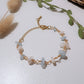 Moon and Sea Bracelet moonstone and aquamarine chip stones gold wire wrapped overhead flat lay with pampas grass and eucalyptus leaves, handmade healing crystal bracelet Sri Lanka – emotional healing inner calm new beginnings Laganna
