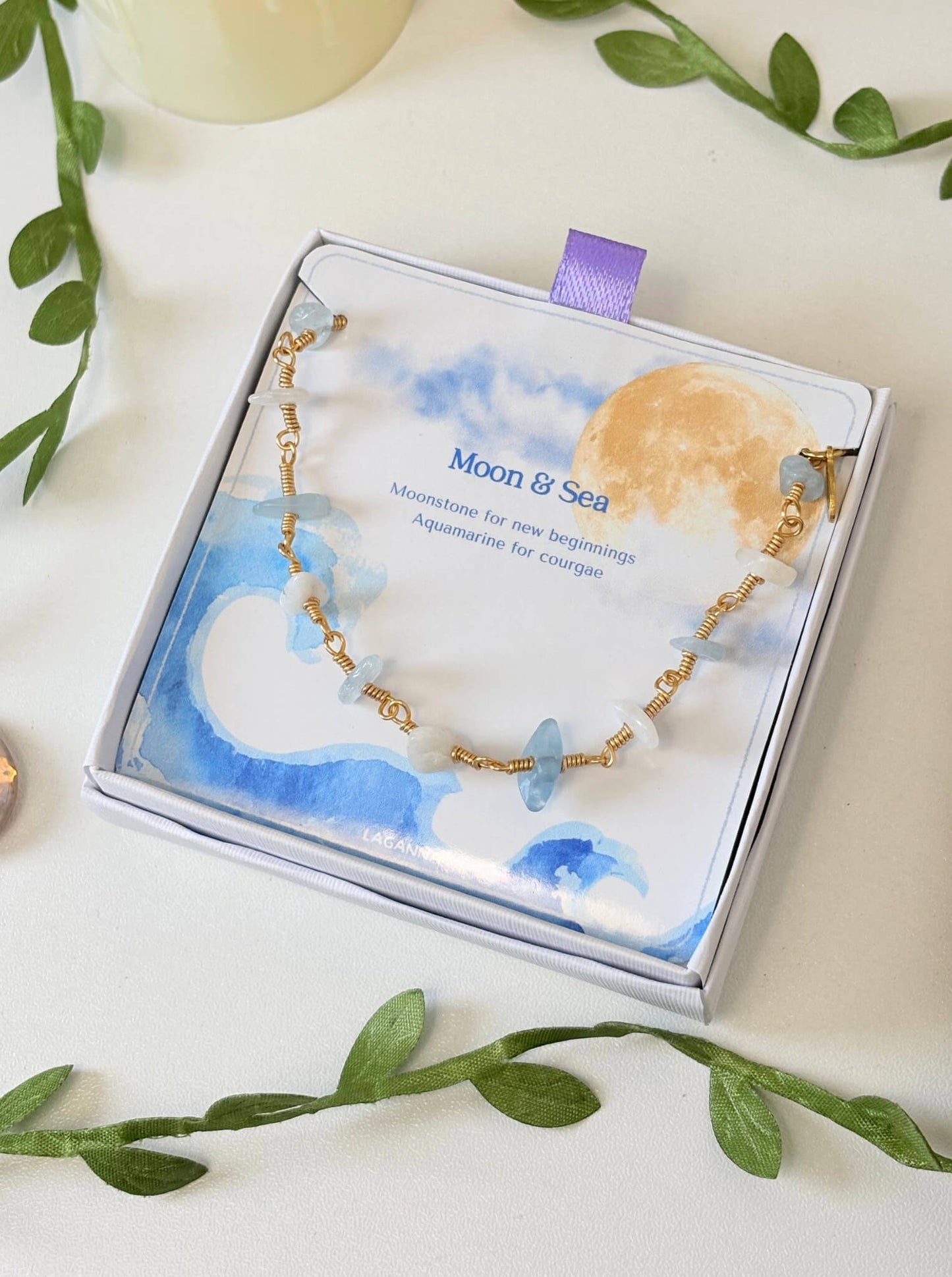 Moon and Sea bracelet with moonstone and aquamarine chip stones laid on Laganna Moon and Sea gift box, handmade Sri Lankan gold wire wrapped dual crystal bracelet for new beginnings and courage
