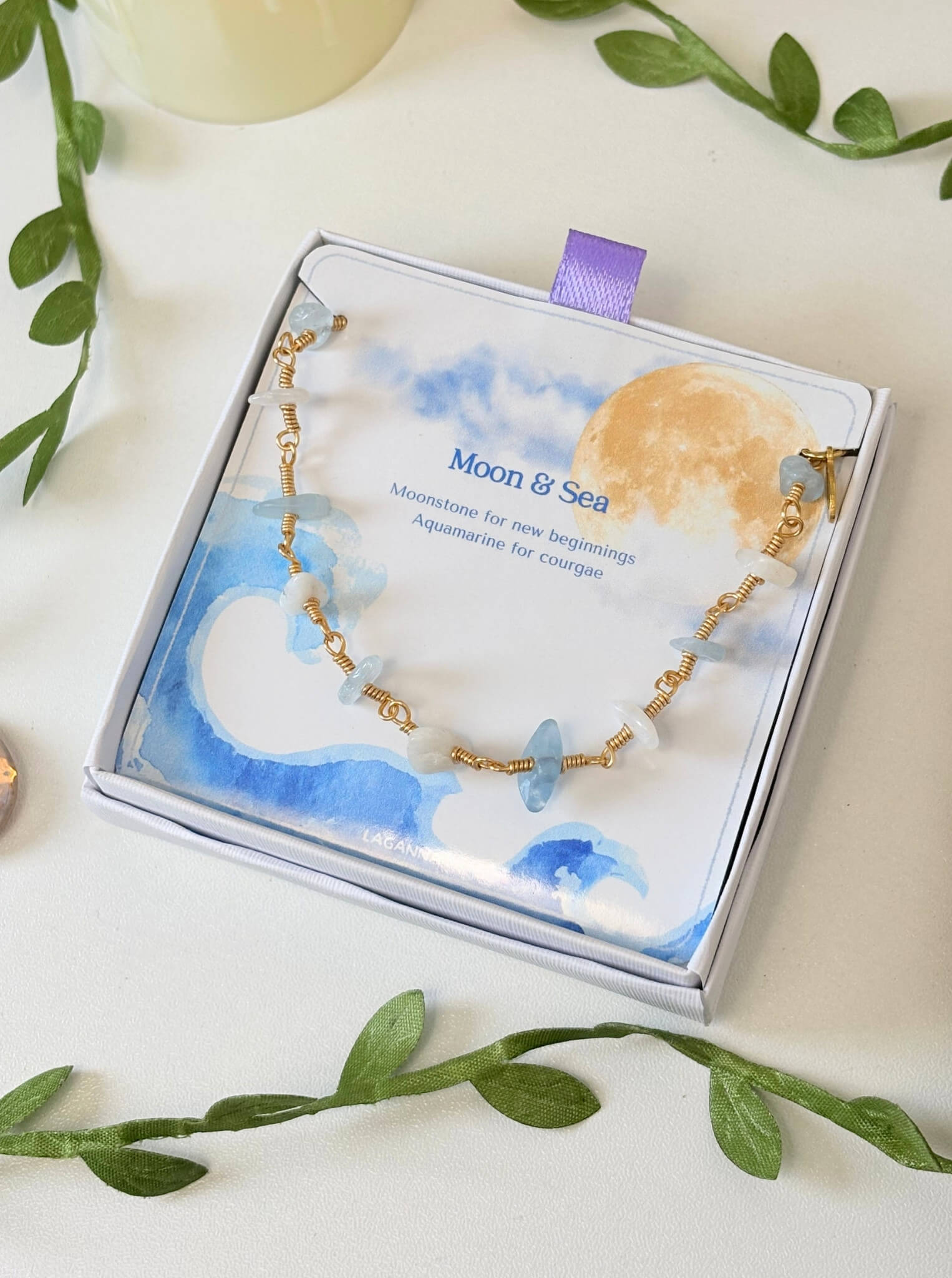 Moon and Sea bracelet with moonstone and aquamarine chip stones laid on Laganna Moon and Sea gift box, handmade Sri Lankan gold wire wrapped dual crystal bracelet for new beginnings and courage

