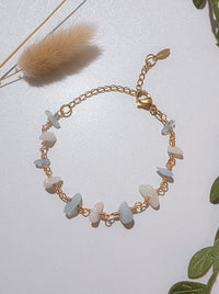 Moon and Sea bracelet flat lay top view showing moonstone and aquamarine chip stones, handmade Sri Lankan gold wire wrapped dual crystal bracelet for emotional healing and inner calm