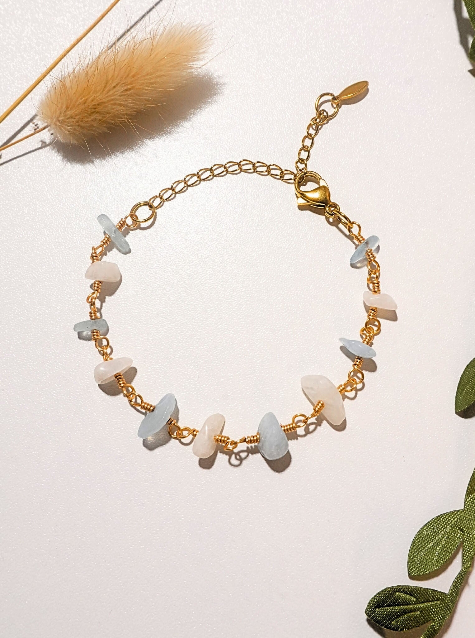 Moon and Sea bracelet flat lay top view showing moonstone and aquamarine chip stones, handmade Sri Lankan gold wire wrapped dual crystal bracelet for emotional healing and inner calm