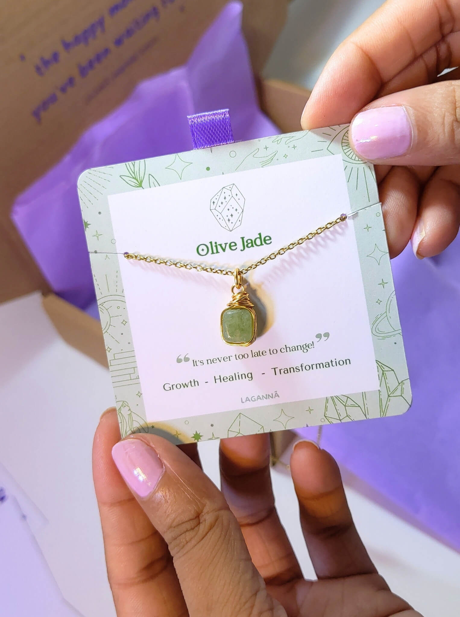 Olive jade square stone necklace jewelry card held in hand showing handmade gold wire wrapped healing crystal gift set, Sri Lankan artisan heart chakra pendant featuring natural square green gemstone perfect as abundance jewelry gift for prosperity and tranquility with elegant presentation