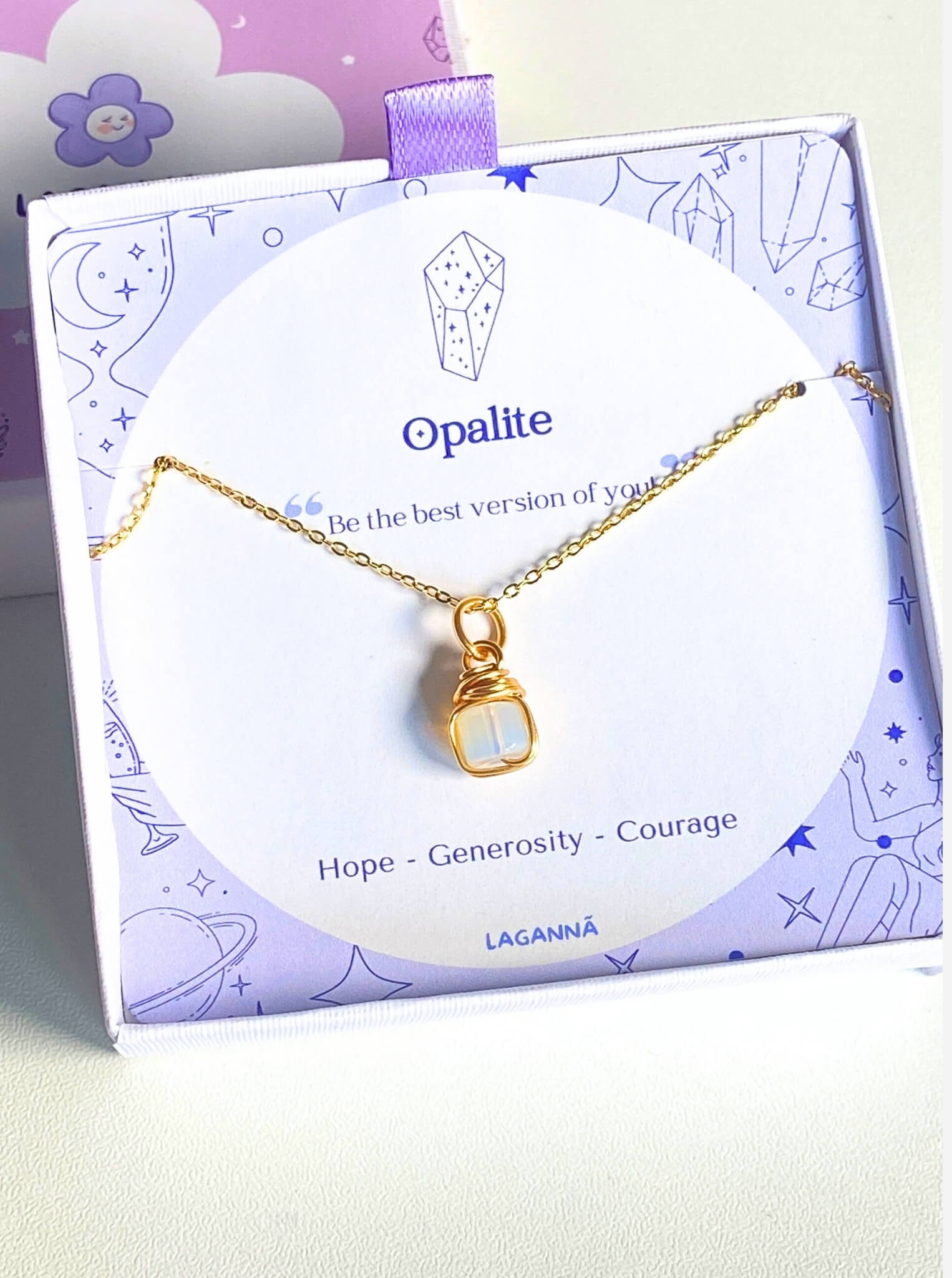 Opalite square stone necklace jewelry box closeup showing gold wire wrapped design, handmade Sri Lankan healing crystal pendant for crown chakra and spiritual clarity