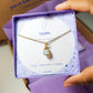 Opalite square stone necklace jewelry box held on hand, handmade Sri Lankan gold wire wrapped healing crystal pendant gift for spiritual awakening