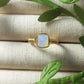 Opalite square stone ring with aesthetic jewelry display, handmade Sri Lankan gold wire wrapped healing crystal ring for spiritual awakening and transformation